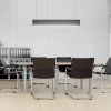 black leather meeting chair around meeting table with office bookcase