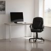 black leather office chair in front of office desk roomshot