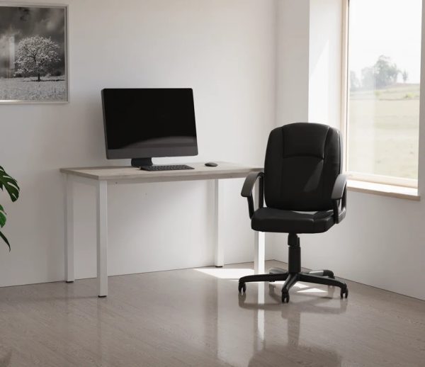 black leather office chair in front of office desk roomshot