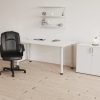 black leather office chair in front of white office desk room shot