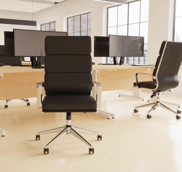 office chair black leather with chrome frame and arms in front of office desk in room shot