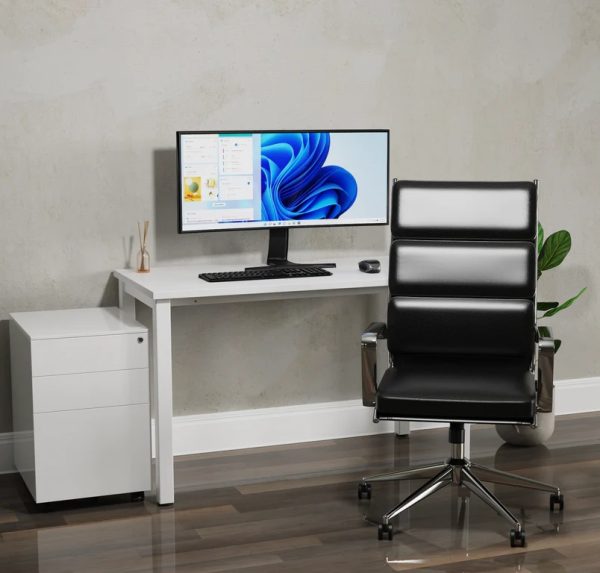 black leather office chair in front of white home office desk and desk pedestal