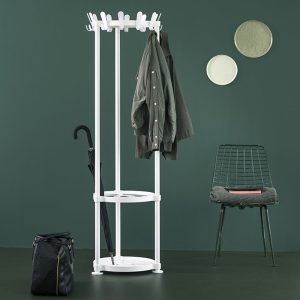 designer coat stand white in room set with dark green walls