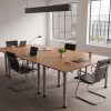 design classic meeting chair in black leather with chrome cantilever leg frame. In room setting around rectangular meeting table