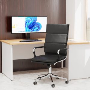 executive high back office chair in black faux leather and chrome frame in room set with white office desk