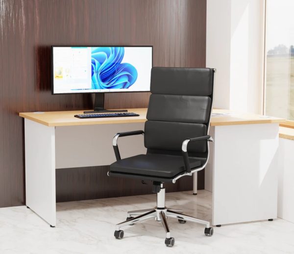 executive high back office chair in black faux leather and chrome frame in room set with white office desk