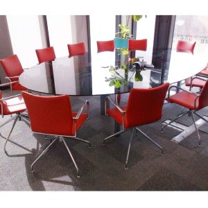 glass meeting table with red meeting chairs