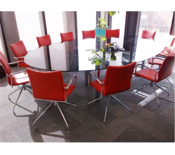 glass meeting table with red meeting chairs