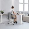 height adjustable desk with lady working. in reception roomset with sofa