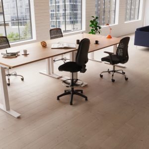 height adjustable desks in office shot with office chairs