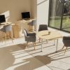 height adjustable desk in room shot with coffee table and office chairs