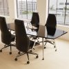 high back black leather executive chairs around meeting table in room set with view of city