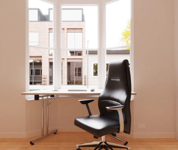 high back executive office chair in black leather in room set in front of desk by window
