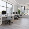 mesh back office chair grey in office room shot with white office desks with view of city