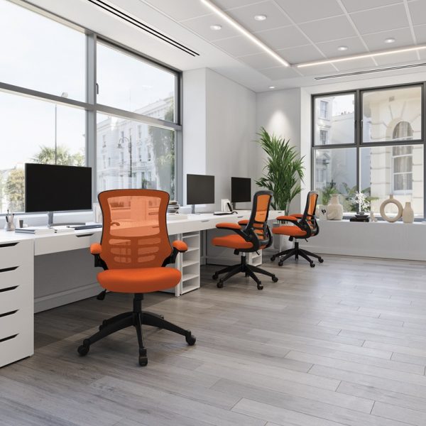 mesh back office chairs orange in room set with white desks and view of city