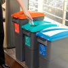 office recycling bins in a row for different waste streams. black with different coloured tops and labelling,