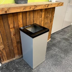 office recycling bins with silver body and black top.