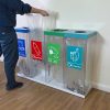 office recycling bin transparent in row of 4 with coloured tops and stickers to indicate waste stream