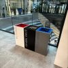 office recycling bins in row in different colours and coloured tops to indicate waste stream