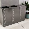 office recycling bin grey in a row with white lettering to indicate waste stream
