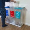 office recycling bin transparent with coloured lids and sticker. Man emptying the bin and replacing bin bag