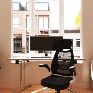 semi circular meeting table in window with black office chair