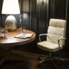 white leather office chair with chrome frame in room shot by round table