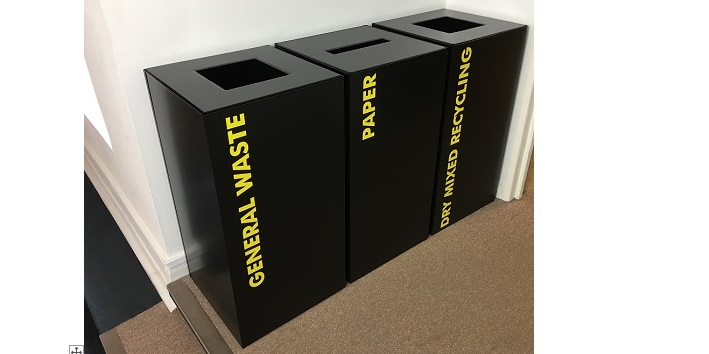 black office recycling bins with yellow lettering