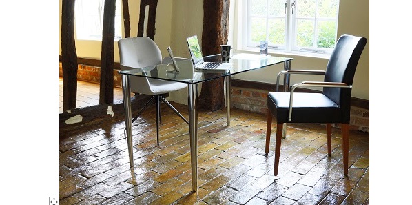 glass desk with chrome legs on old house