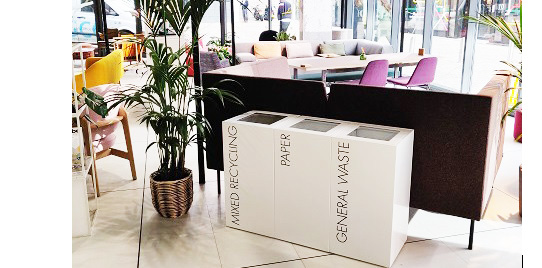 row of white office recycling bins in reception area