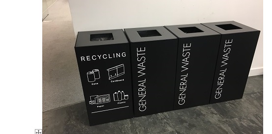 row of black office recycling bins with white lettering and pictograms