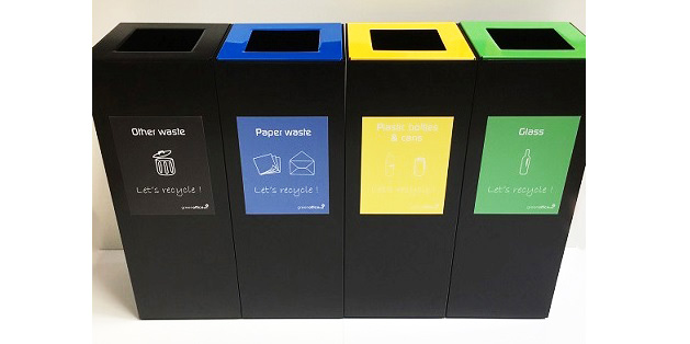 row of black office recycling bins with coloured stickers and tops for different waste streams