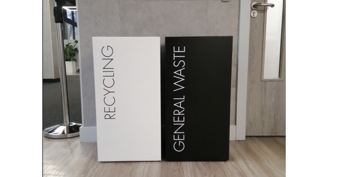 black recycling bin with white lettering General Waste. and white recycling bin with black lettering Recycling