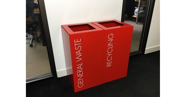 red office recycling bins with white lettering