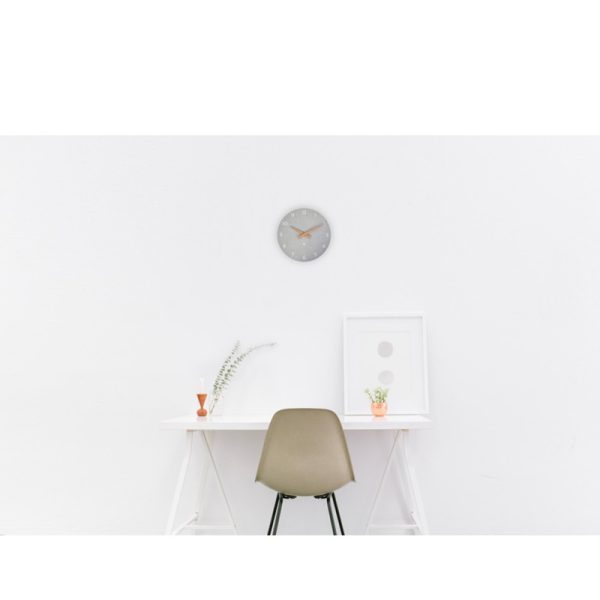 contemporary office clock in grey finish with wood hands and white numerals in office room set with office desk and office chair