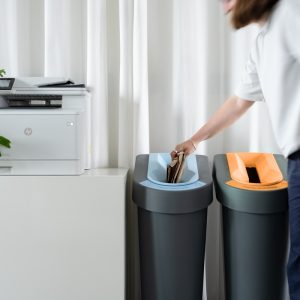 slim office recycling bins by photocopier with lady putting paper in bin