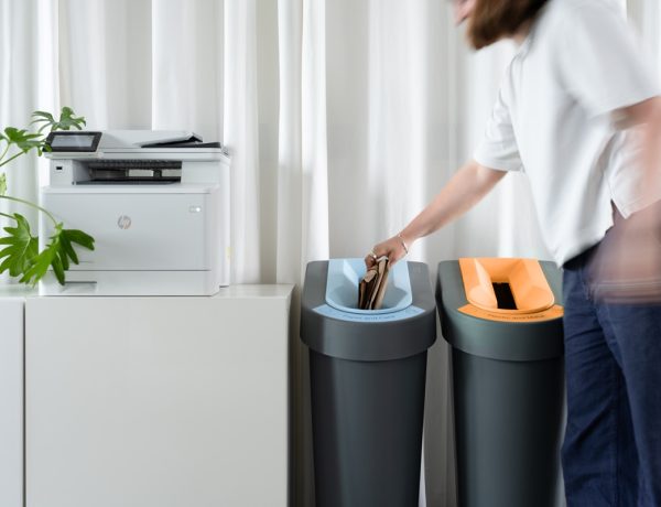 slim office recycling bins by photocopier with lady putting paper in bin