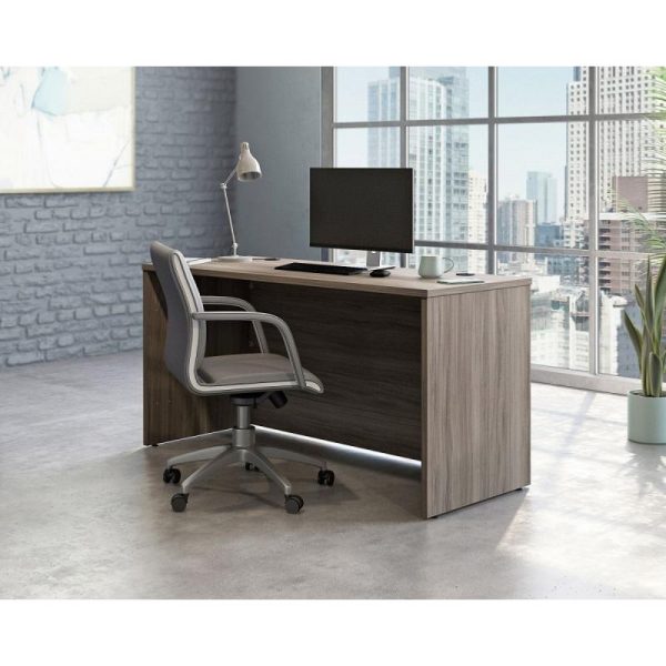 Stylish panel end office desk in attractive elm finish in room set with office chair and city view