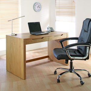 black leather office chair in front of office desk in room set