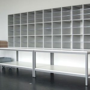 grey post sorter unit on mailroom table with post trolley by the side