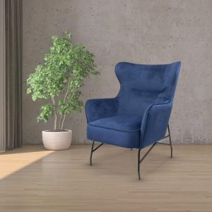 lounge chair in blue fabric in room shot with small tree